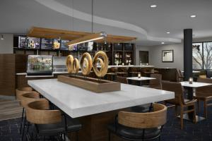 a restaurant with a table and chairs and a bar at Courtyard Danville in Danville