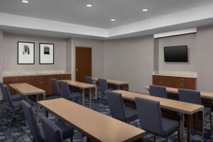 a classroom with tables and chairs and a flat screen tv at Courtyard Danville in Danville +24 photos