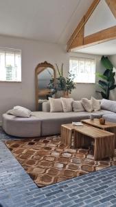 a living room with a couch and a table at Somers Loft in Zuid-Beijerland