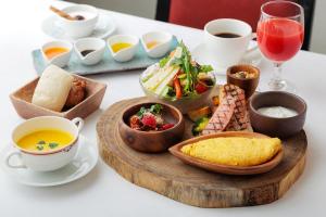 a table with a tray of food and cups of tea at Tokyo Asakusabashi Belmont Hotel in Tokyo