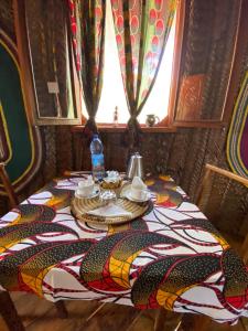 a table in a room with a table cloth on it at Baobab Lagoon in Mtende