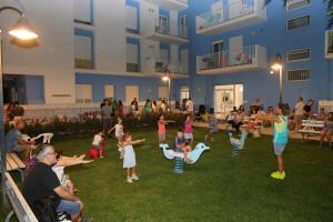 a group of children playing in the yard of a building at Residence I Delfini in Cupra Marittima +82 photos