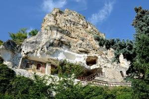 a house built into the side of a mountain at INCANTO Apartment in Ruse
