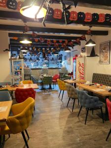 a restaurant with tables and chairs and a bar at Casa Veche in Runcu