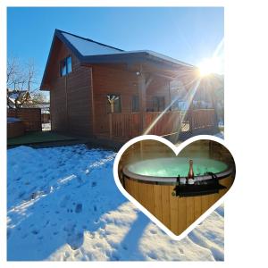 a hot tub in the shape of a heart in front of a house at Domek w Zabrzeży in Łącko