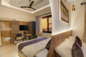 a bedroom with a bed and a desk at Sharnam On The Ganges in Rishīkesh