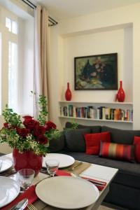 a living room with a couch and a table with plates at Apartment Bac St. Germain in Paris