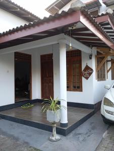 a house with a car parked in front of it at Bright Nest Villa in Matara