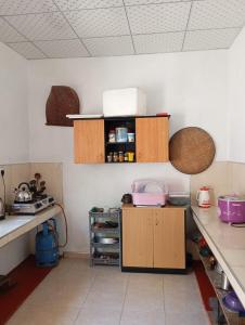 a kitchen with wooden cabinets and a counter top at Bright Nest Villa in Matara