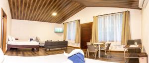 a hotel room with a bed and a table and chairs at Termales del Arenal in Fortuna