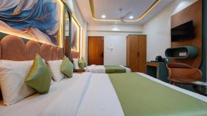 a hotel room with a large bed and a tv at Hotel Balaji Residency Dombivali in Dombivli