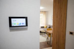 a living room with a tv on a wall at Muki Park Lake in Tuzla