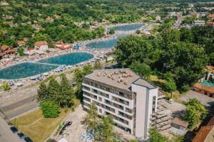an aerial view of a hotel and a river at Muki Park Lake in Tuzla