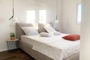 a bed with two pillows on it in a room at Hacienda Lucio in Grohote +23 photos