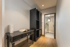 a black desk in a room with a glass door at Aurora Hotel & Apartment in Hanoi