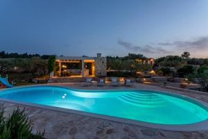 a swimming pool in front of a house at Hacienda Lucio in Grohote