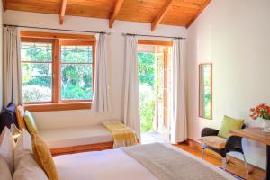 a bedroom with a bed and a window at The Church Accommodation in Hahei