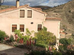 una casa en las montañas con flores en Casa Lola, en Pelegrina