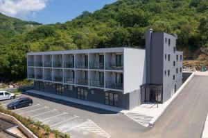 an aerial view of a building with a parking lot at Dubrave apartmani in Budva