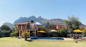 a house with a swimming pool next to a house at Hotel Boutique Jardín de Flores in Tlayacapan