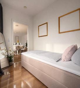 a bedroom with a large white bed and a dining room at Penthouse mit Deisterblick & Balkon in Barsinghausen