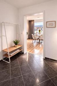 a living room with a tiled floor and a dining room at Penthouse mit Deisterblick & Balkon in Barsinghausen