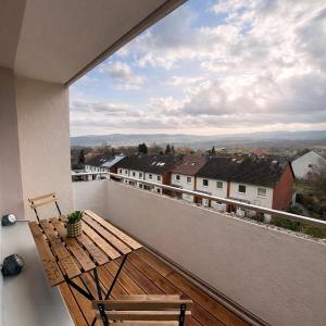 a balcony with a wooden bench and a view at Penthouse mit Deisterblick & Balkon in Barsinghausen