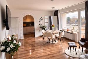a dining room and kitchen with a table and chairs at Penthouse mit Deisterblick & Balkon in Barsinghausen
