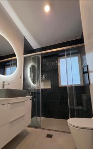 a bathroom with a shower and a sink and a toilet at Sea, La Vie in Saronida +25 photos
