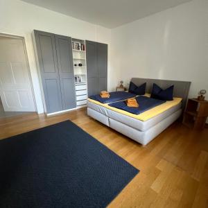 a bedroom with a bed with blue sheets and blue pillows at Ferienwohnung Marie in Bad Elster