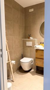 a bathroom with a toilet and a sink at Cozy Studio with Pool in Middelkerke 4 Guests in Middelkerke +9 photos