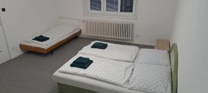 two twin beds in a room with a window at U Piškota in Desná