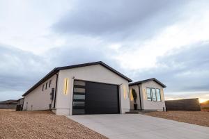 a white house with a large garage at The Mustang Collection 55 in Page