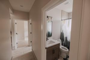 a white bathroom with a toilet and a sink at The Mustang Collection 55 in Page +23 photos