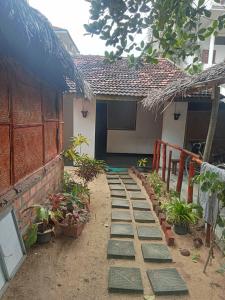 a garden with stepping stones in front of a house at Ceylon Bay in Arugam Bay