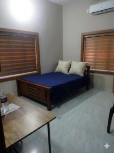 a bedroom with a bed with blue sheets and two pillows at Sree durga Villa Homestay in Kodoth