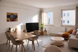 a living room with a table and a couch at Rue118 in Essen