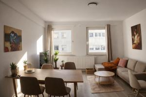 a living room with a table and a couch at Rue118 in Essen