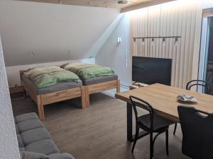 a room with a bed and a table and a tv at Ferienwohnung Lang in Nittenau