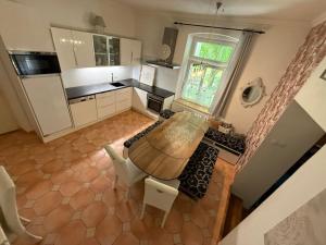 an overhead view of a kitchen with a table and chairs at Apartmány Villa Magnolie in Lipova Lazne