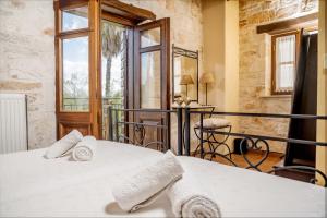 a bedroom with a bed and a large window at Grantzaos Villas in Laganas +58 photos