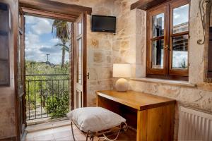 a room with a wooden desk and a window at Grantzaos Villas in Laganas