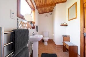 a bathroom with a sink and a toilet at The Church Accommodation in Hahei +108 photos