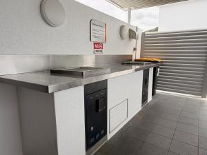 a kitchen with a counter with a sink and a stove at TJ Homes in Ross Island