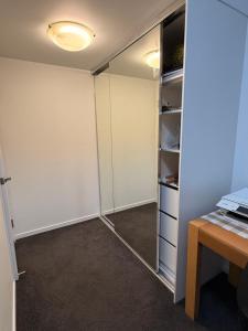 a room with a closet with a desk and a table at TJ Homes in Ross Island +7 photos