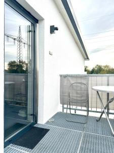 a patio with a chair and a table on a balcony at Three bedroom apartment in Dingolfing