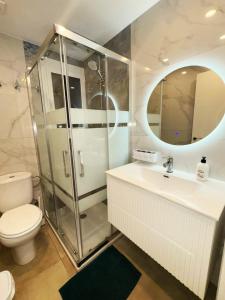 a bathroom with a shower and a toilet and a sink at Apartamento Cabrera Montserrat in Cabrera de Mar +22 photos