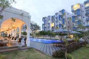 a hotel with a swimming pool in front of a building at Santorini Negombo in Negombo