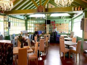 a dining room with tables and chairs and chandeliers at Royal Tennis Club in Marbella
