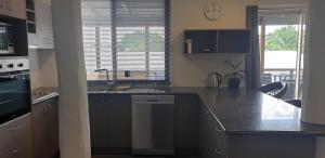 a kitchen with a sink and a counter top at Gympie Townhouse in Gympie +1 photo